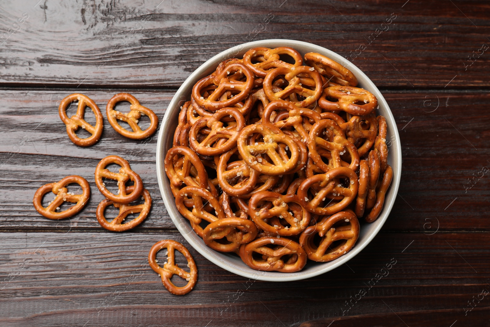 Photo of Tasty pretzel crackers on wooden table, top view