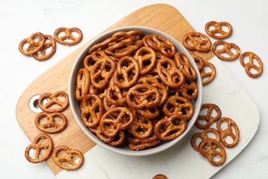 Photo of Tasty pretzel crackers on white table, top view