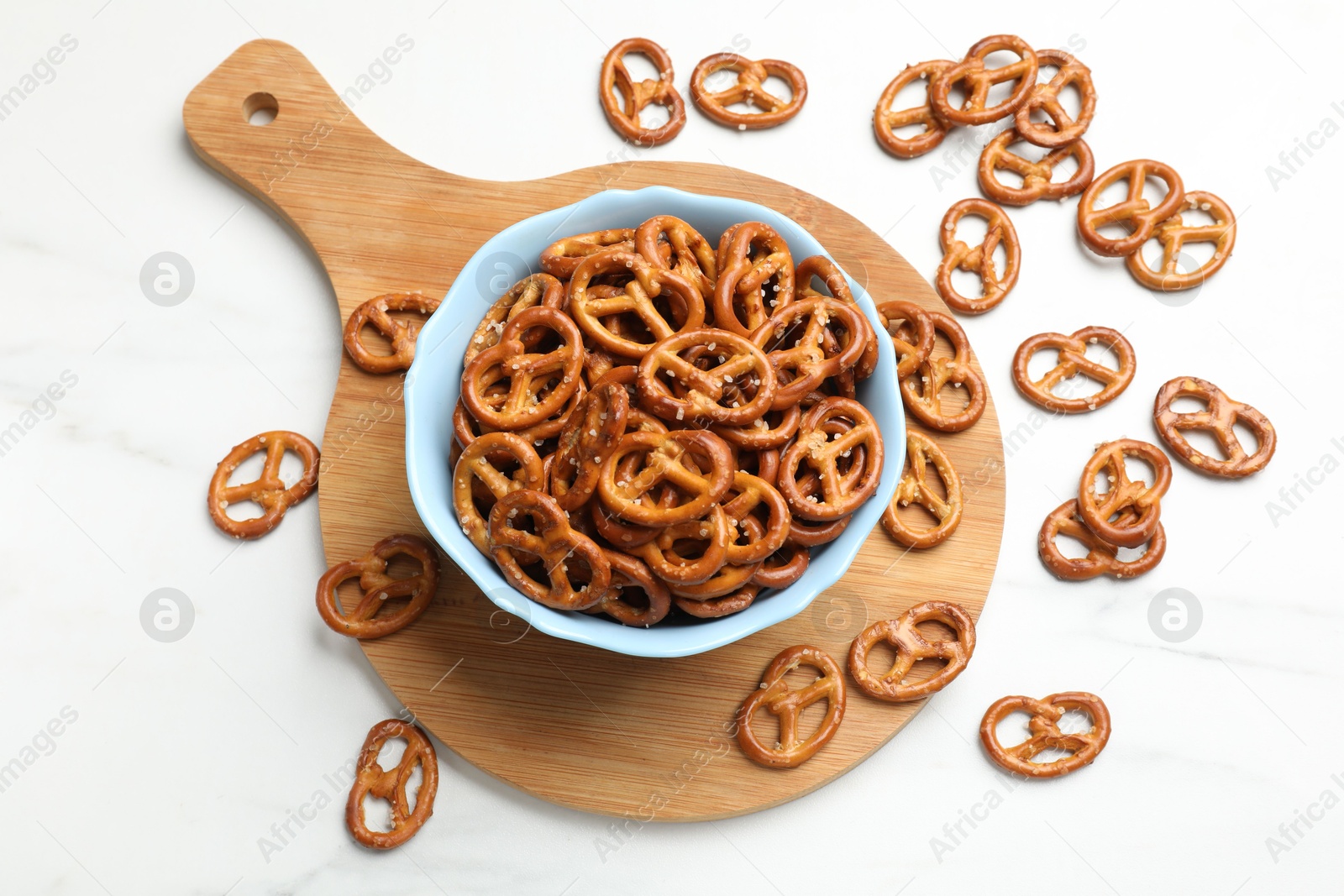 Photo of Tasty pretzel crackers on white table, top view