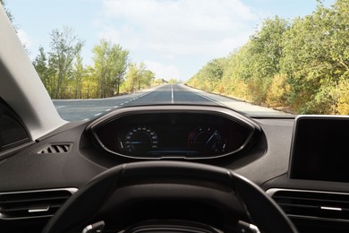 Image of Car driving on empty road, view from driver's seat