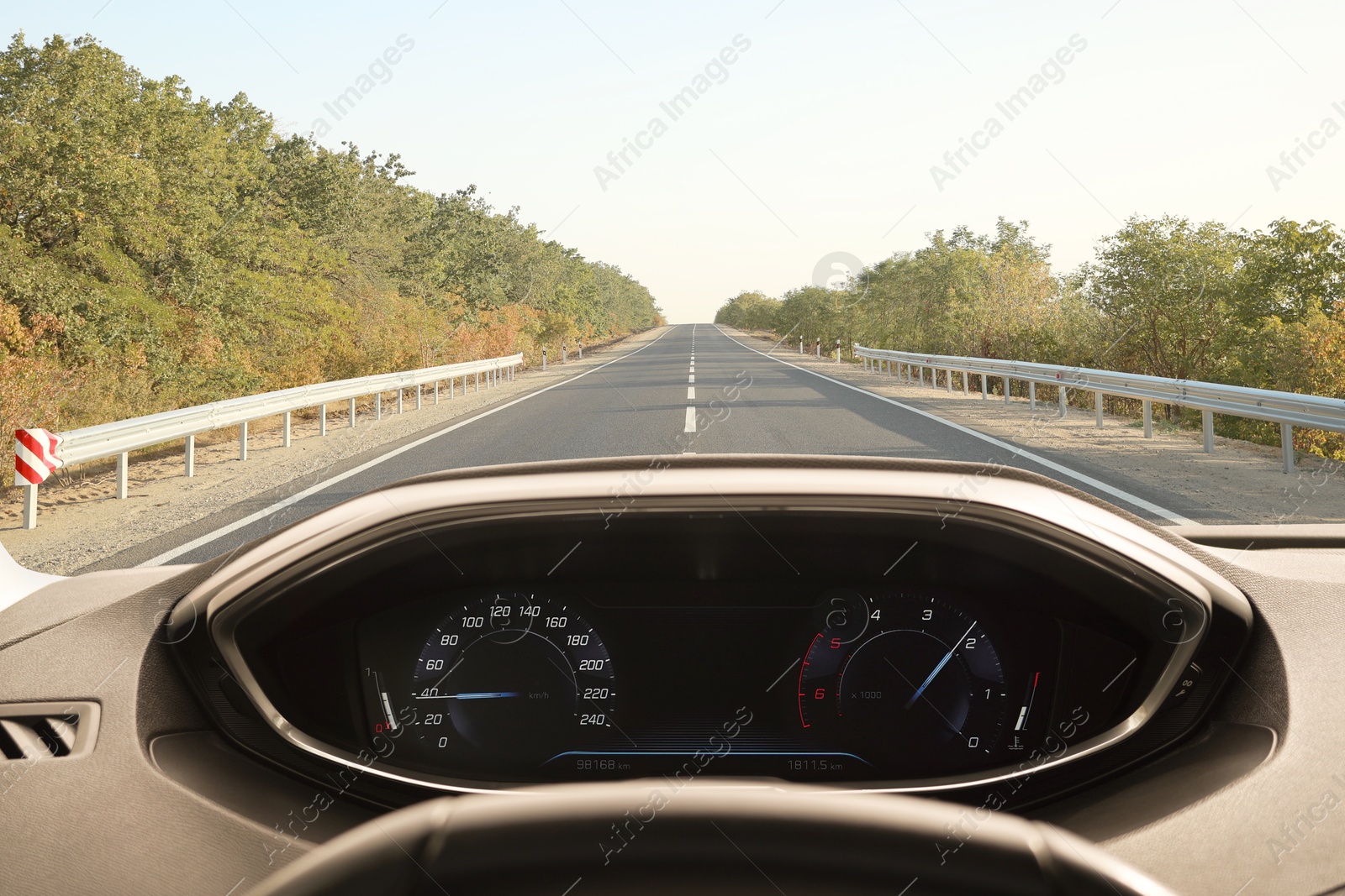 Image of Car driving on empty road, view from driver's seat