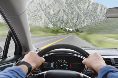 Man driving car on mountain road at high speed, first-person view. Motion blur effect