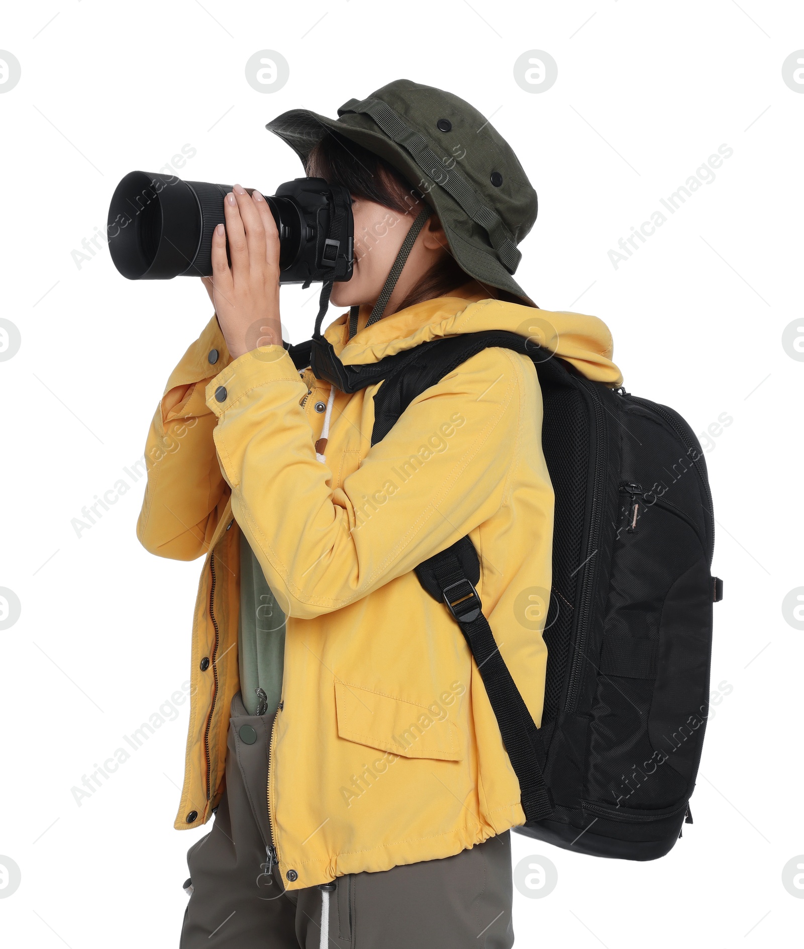 Photo of Photographer with backpack and camera taking picture on white background