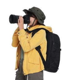 Photographer with backpack and camera taking picture on white background