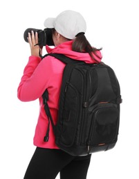 Photographer with backpack and camera taking picture on white background