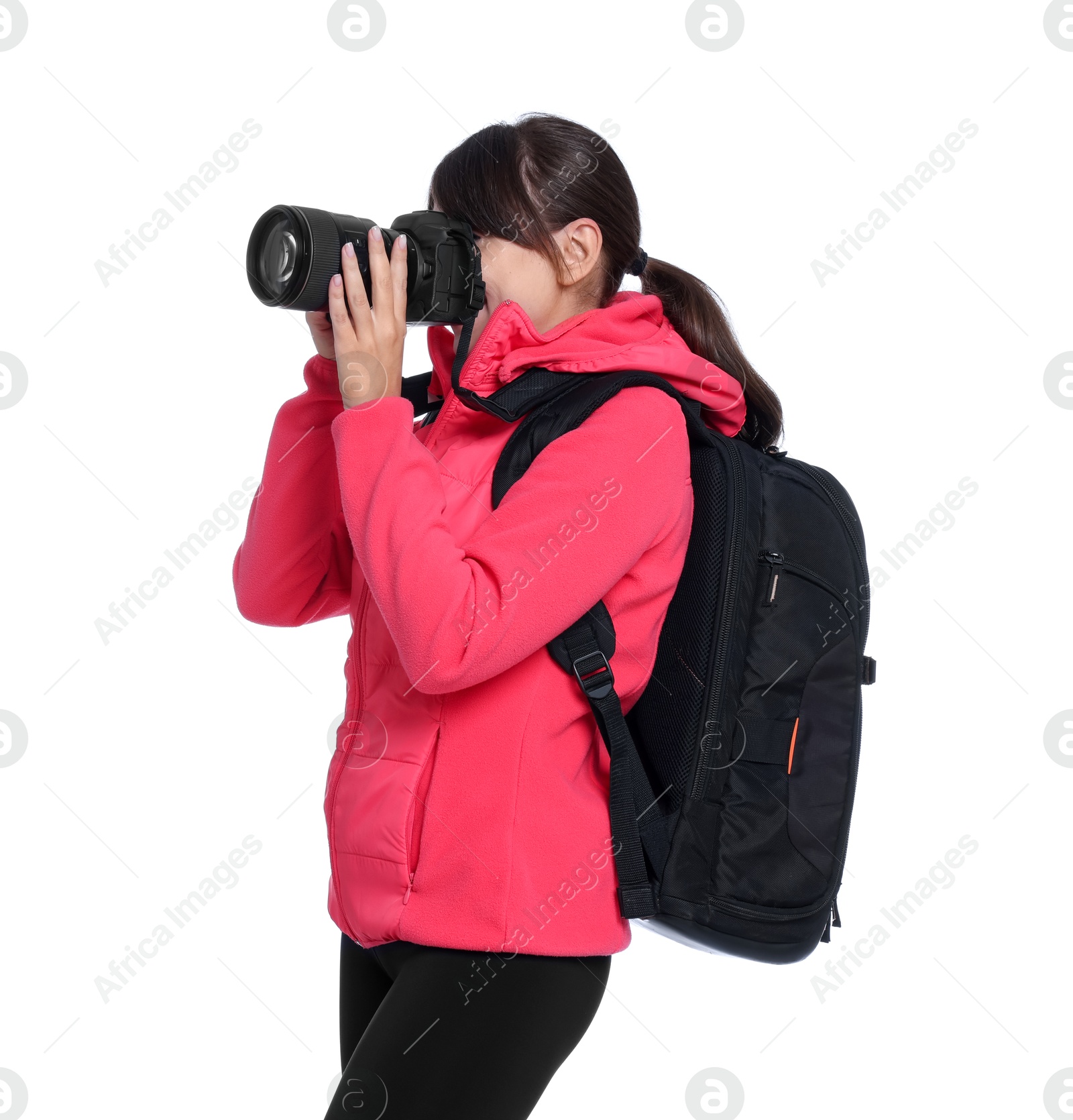 Photo of Photographer with backpack and camera taking picture on white background