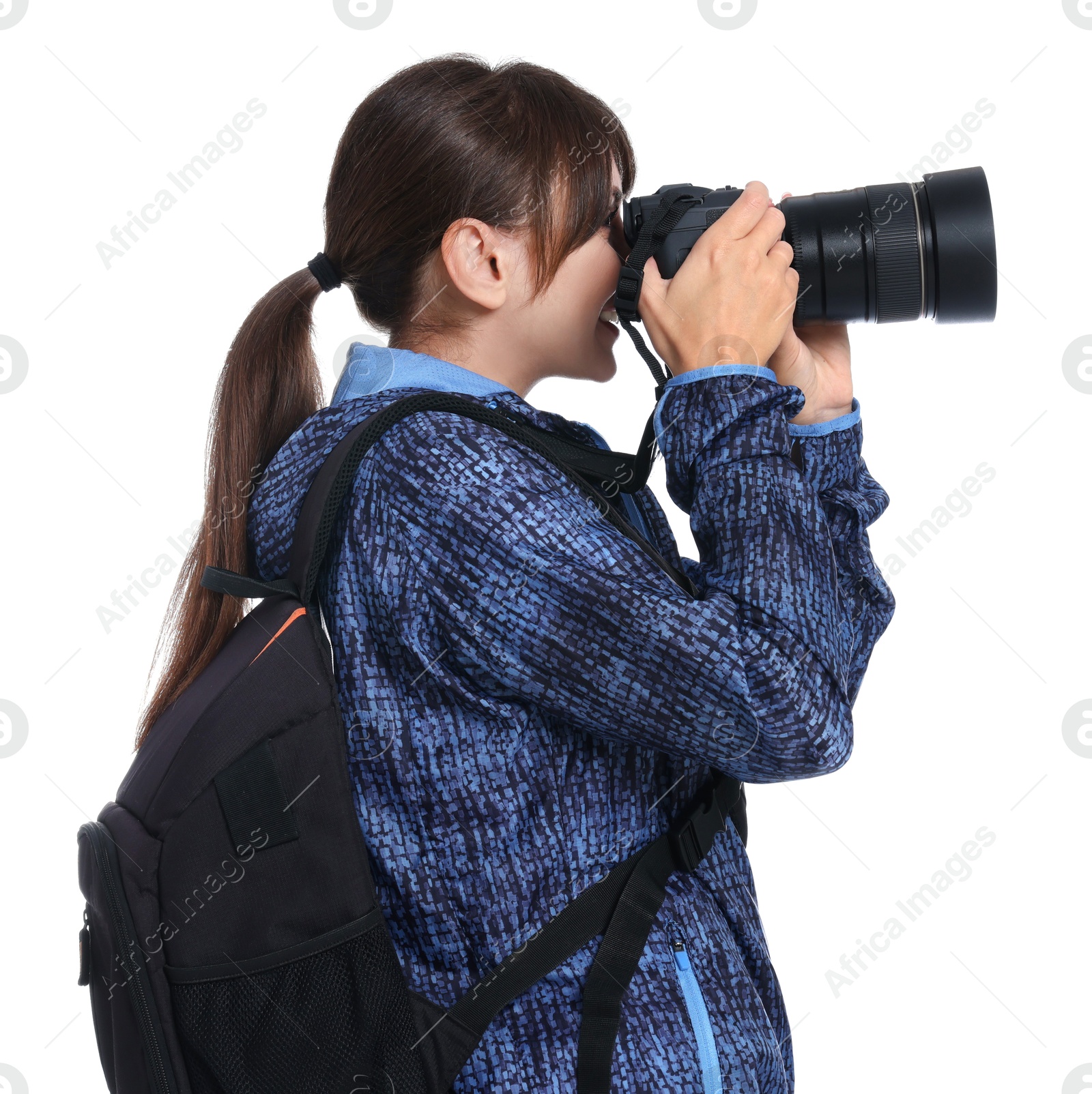 Photo of Photographer with backpack and camera taking picture on white background