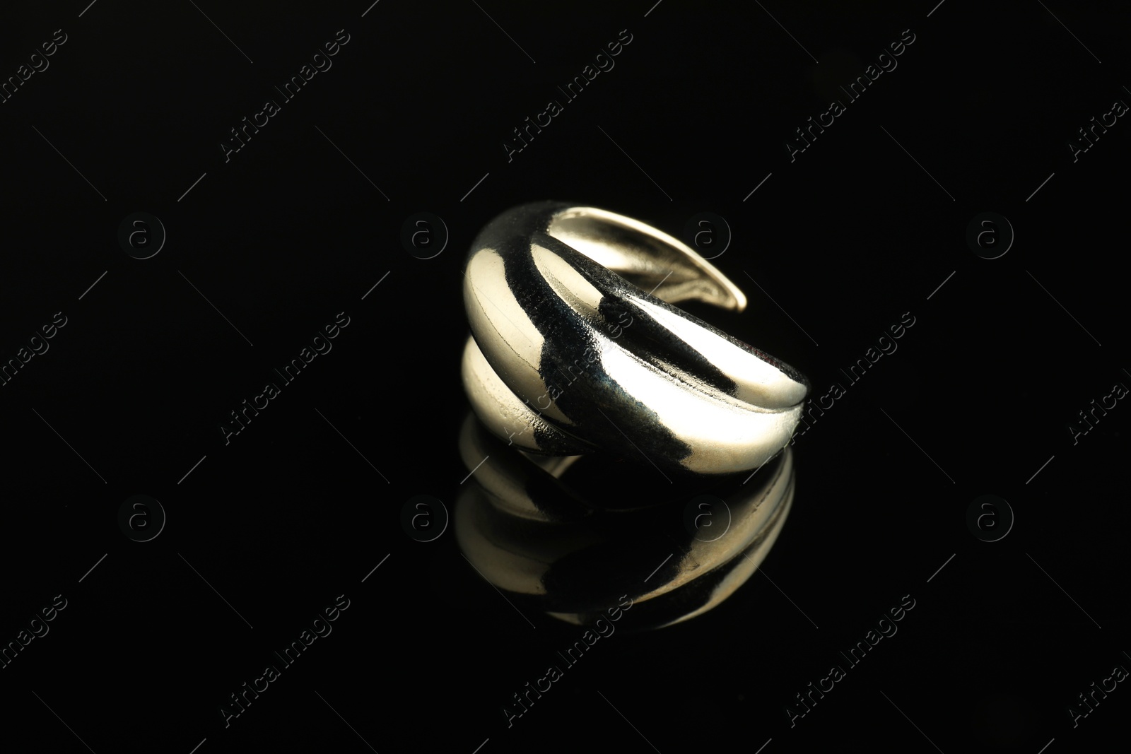 Photo of Beautiful bijouterie. Stylish ring on black background