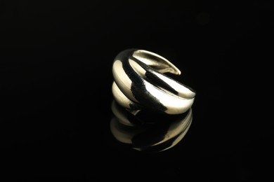 Beautiful bijouterie. Stylish ring on black background