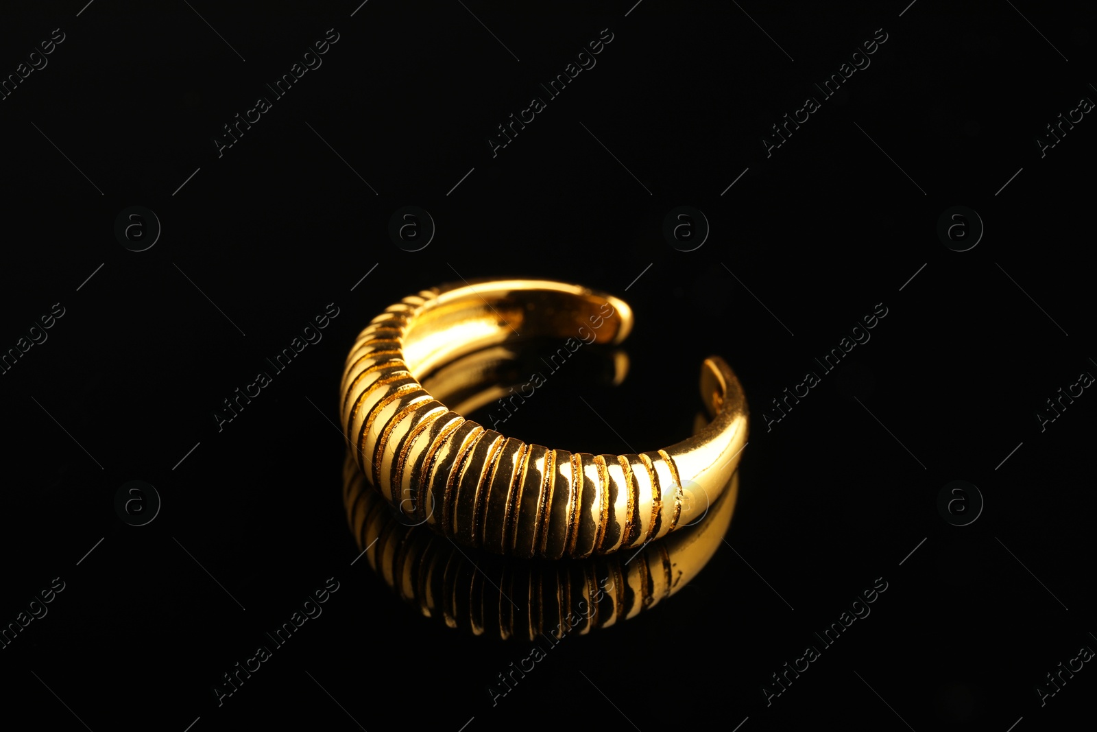 Photo of Beautiful bijouterie. Stylish ring on black background