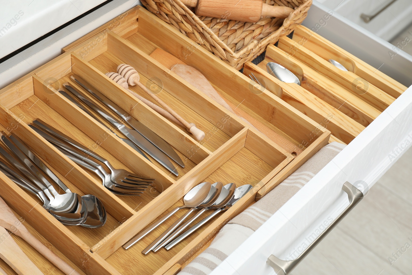 Photo of Box with cutlery in drawer, closeup. Kitchen utensils storage