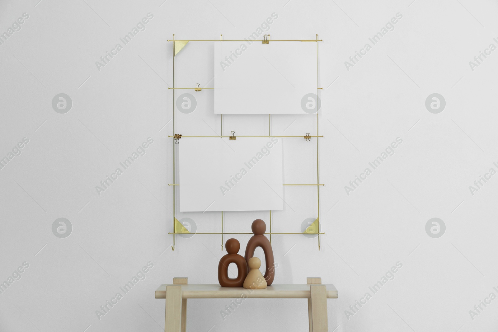 Photo of Mood board with blank paper notes and decorative figures on wooden ladder near white wall