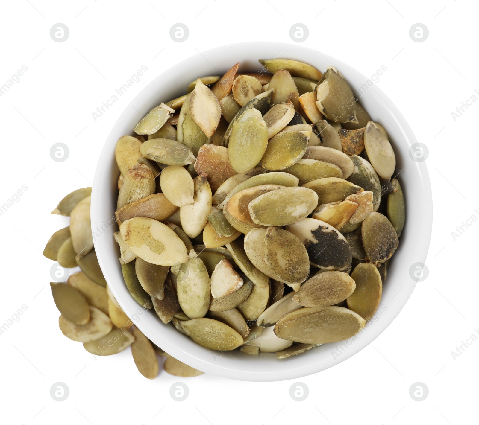 Photo of Peeled pumpkin seeds in bowl isolated on white, top view