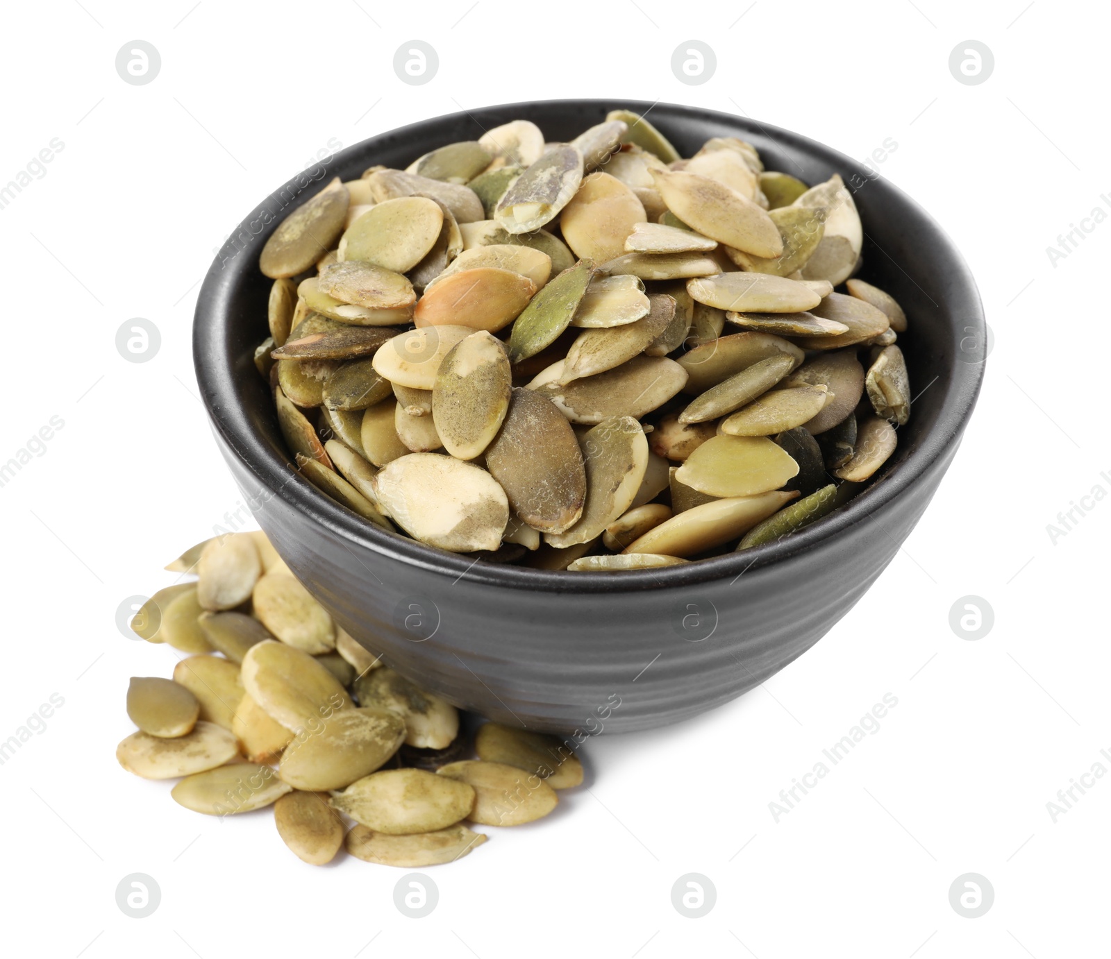 Photo of Peeled pumpkin seeds in bowl isolated on white