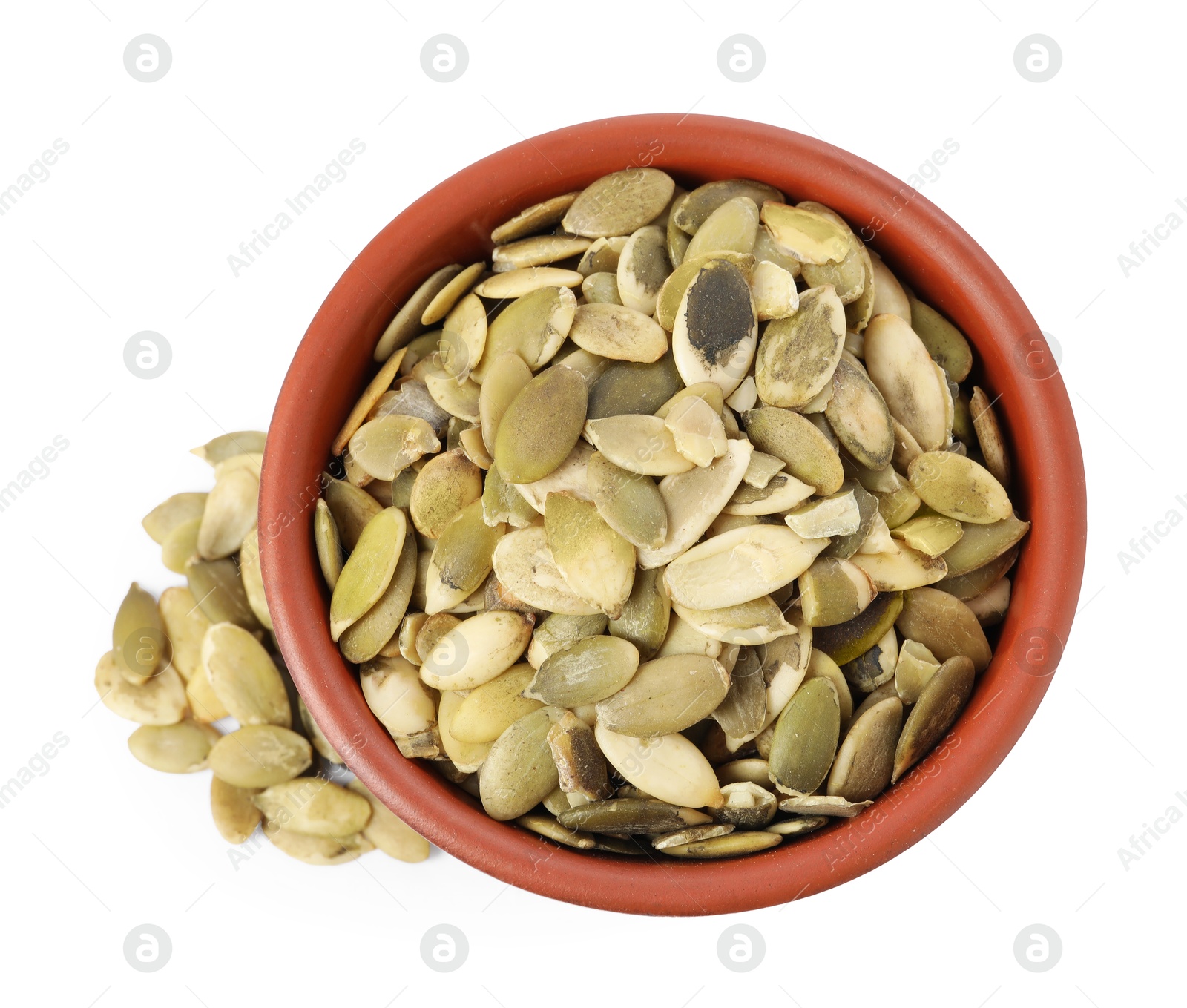 Photo of Peeled pumpkin seeds in bowl isolated on white, top view