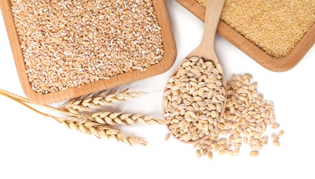 Photo of Different types of cereals and spikelets isolated on white, top view