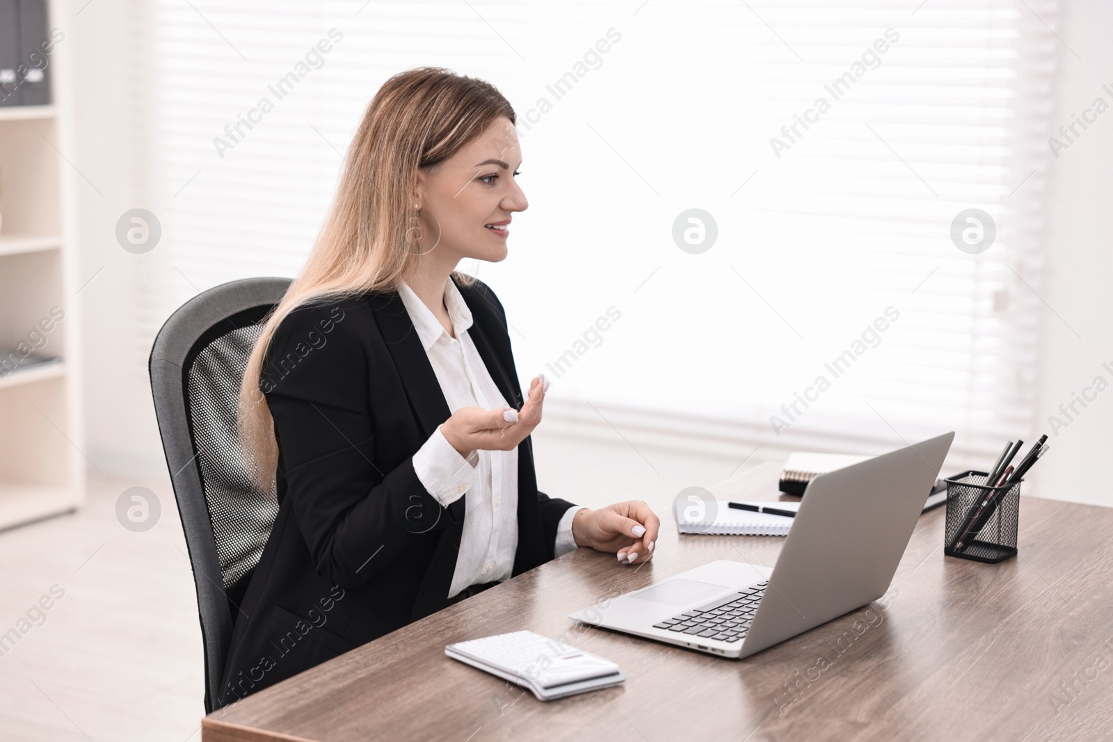 Photo of Banker with laptop working at table in office