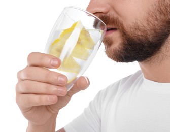 Photo of Man drinking water with lemon on white background, closeup