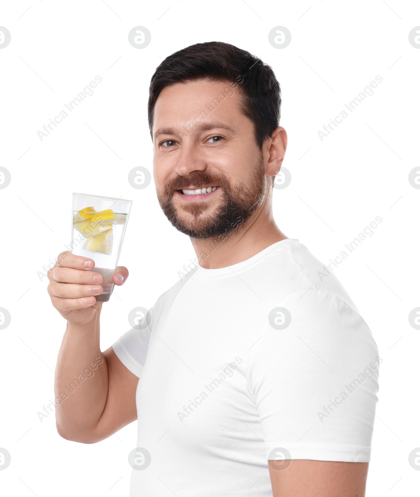 Photo of Happy man holding glass of water with lemon on white background