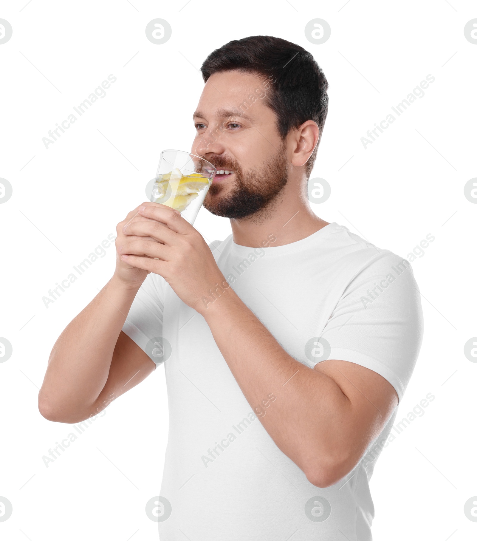 Photo of Happy man drinking water with lemon on white background