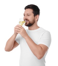 Photo of Happy man drinking water with lemon on white background