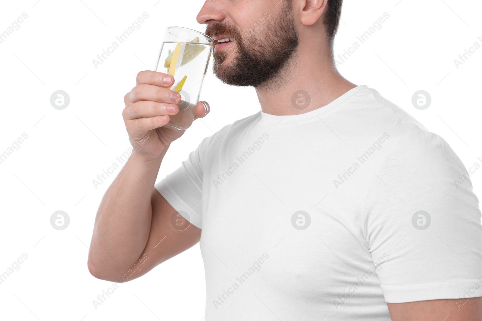 Photo of Man drinking water with lemon on white background, closeup