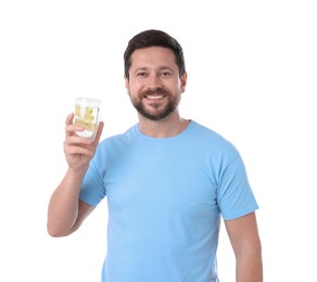 Photo of Happy man holding glass of water with lemon on white background