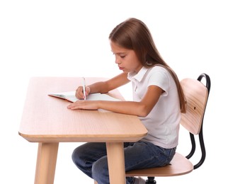 Photo of Girl with incorrect posture and notebook sitting at wooden desk on white background