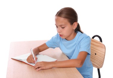 Photo of Girl with incorrect posture and notebook sitting at wooden desk on white background