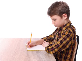 Boy with correct posture and notebook at wooden desk on white background