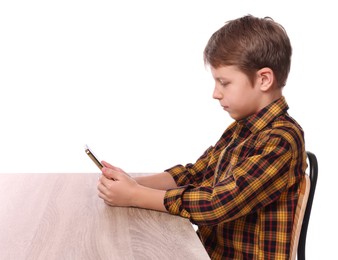 Photo of Boy with correct posture and phone at wooden desk on white background