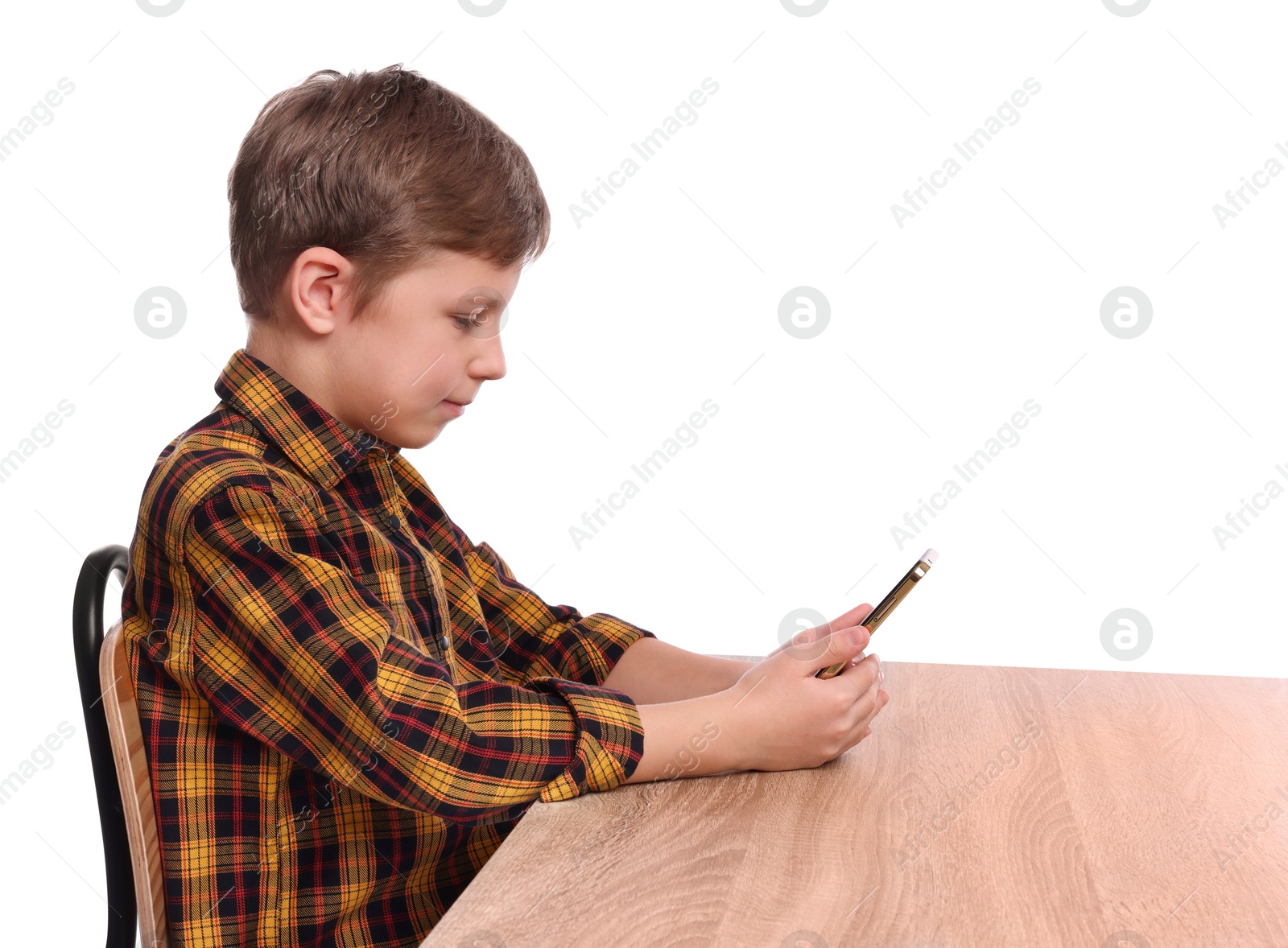 Photo of Boy with correct posture and phone at wooden desk on white background