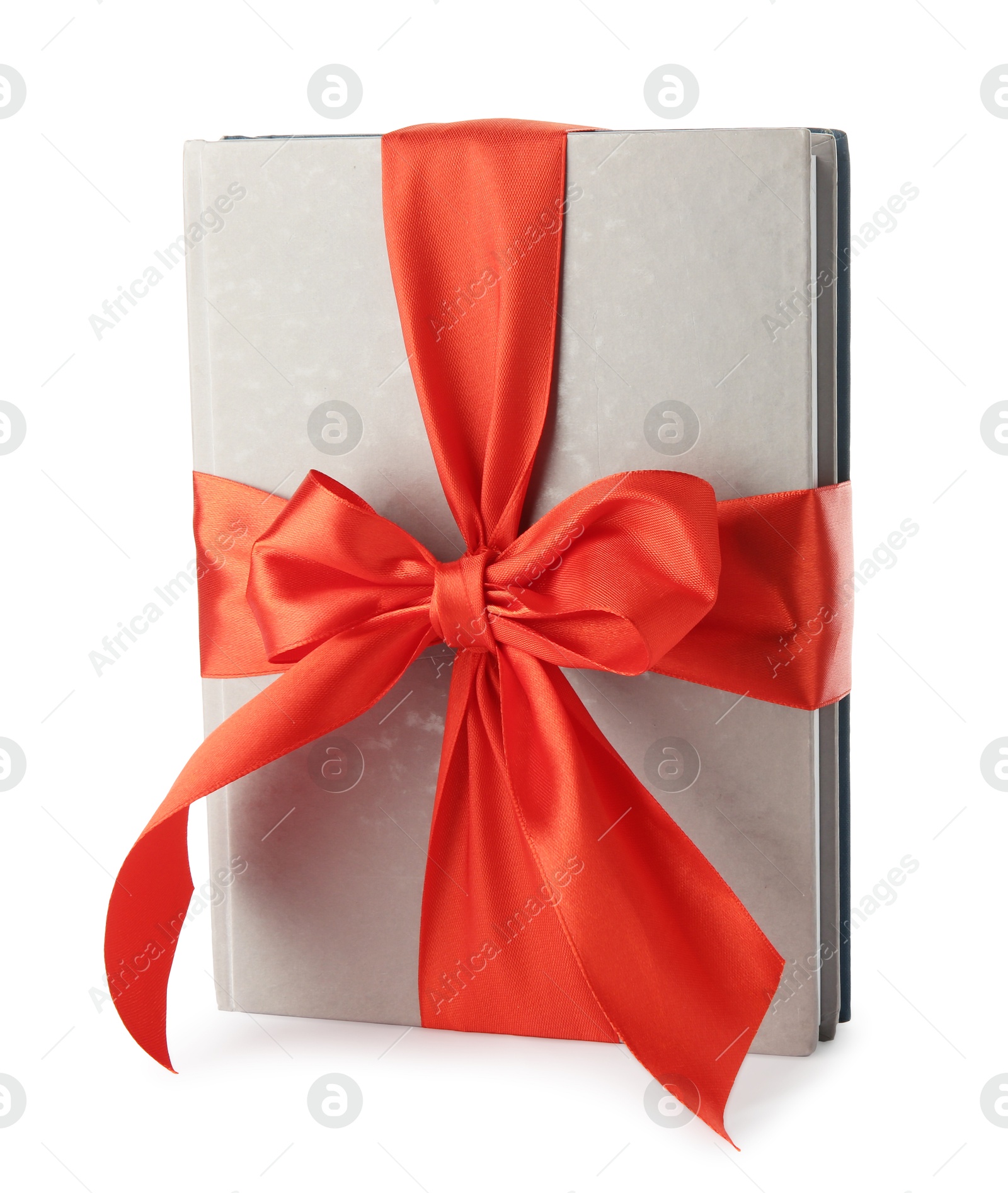 Photo of Book with ribbon as gift isolated on white