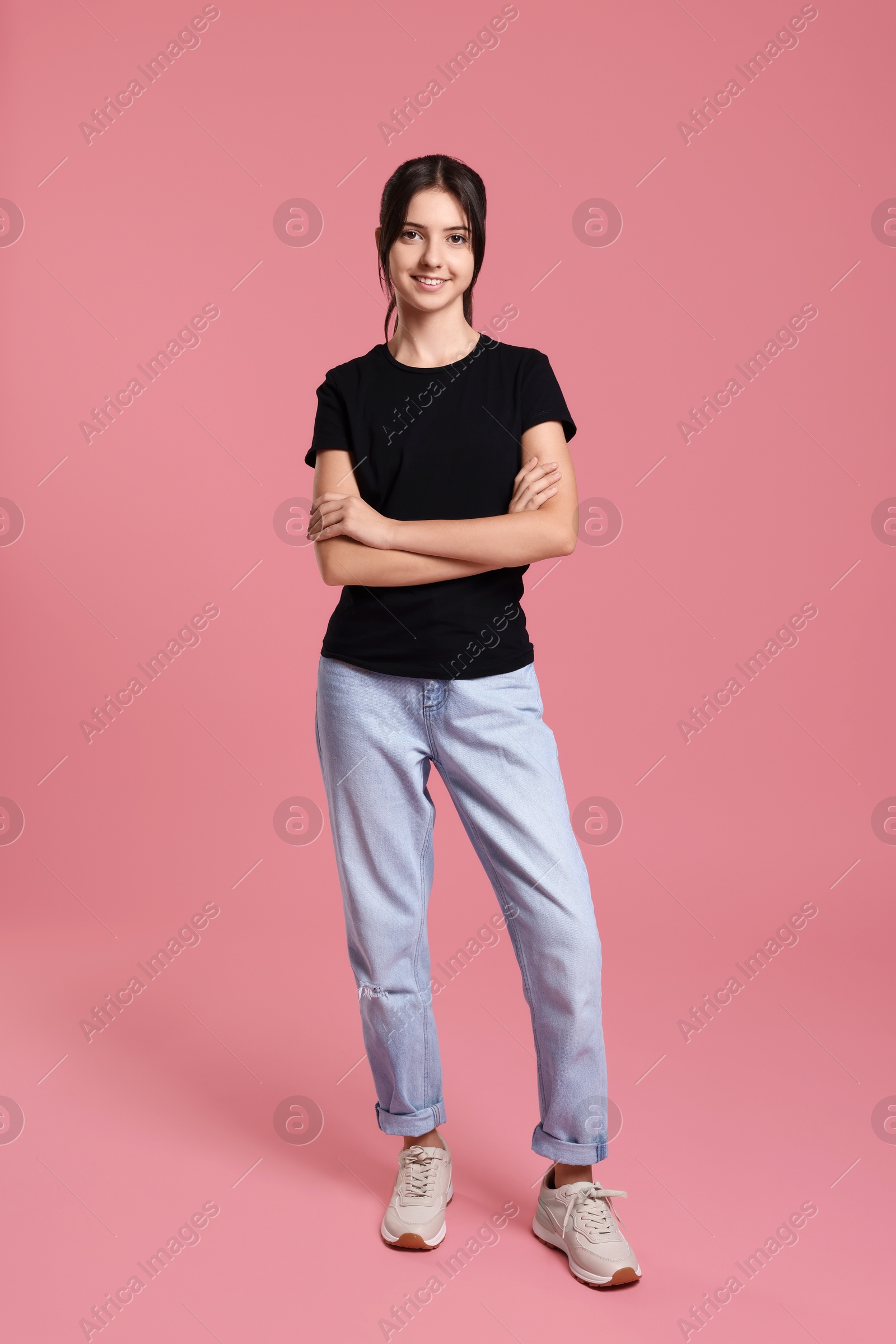 Photo of Full length portrait of cute teenage girl on pink background