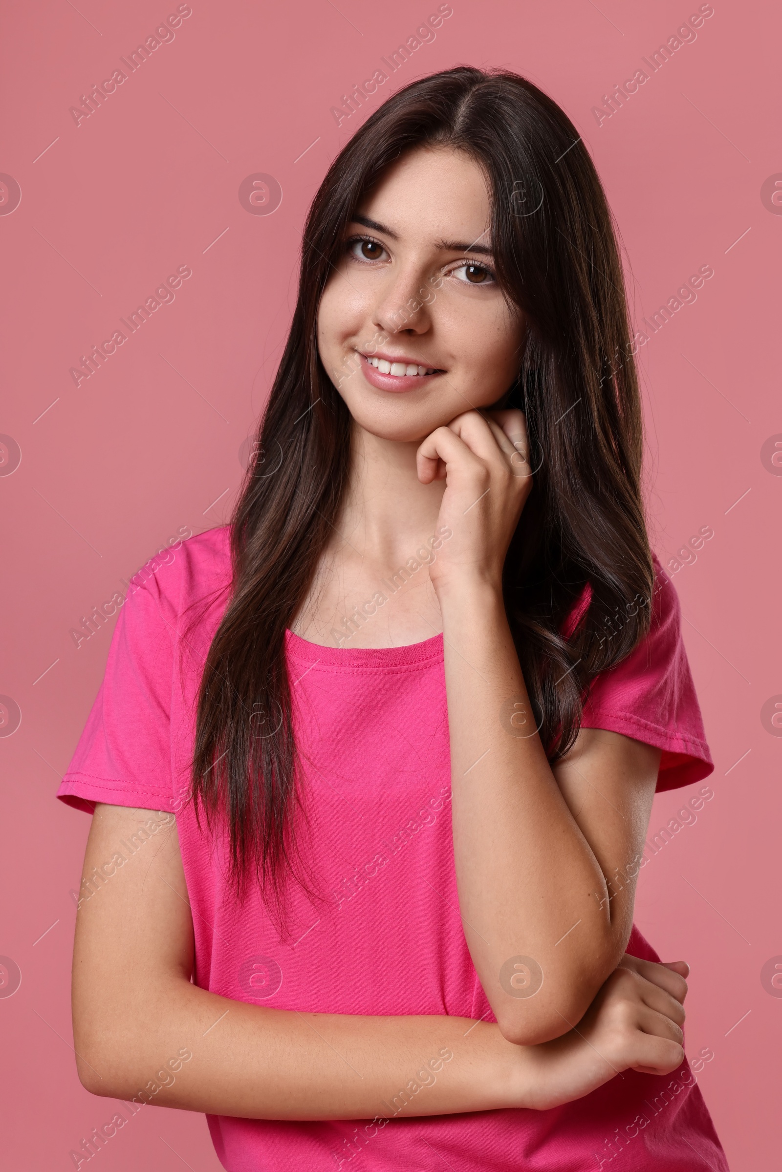 Photo of Portrait of cute teenage girl on pink background