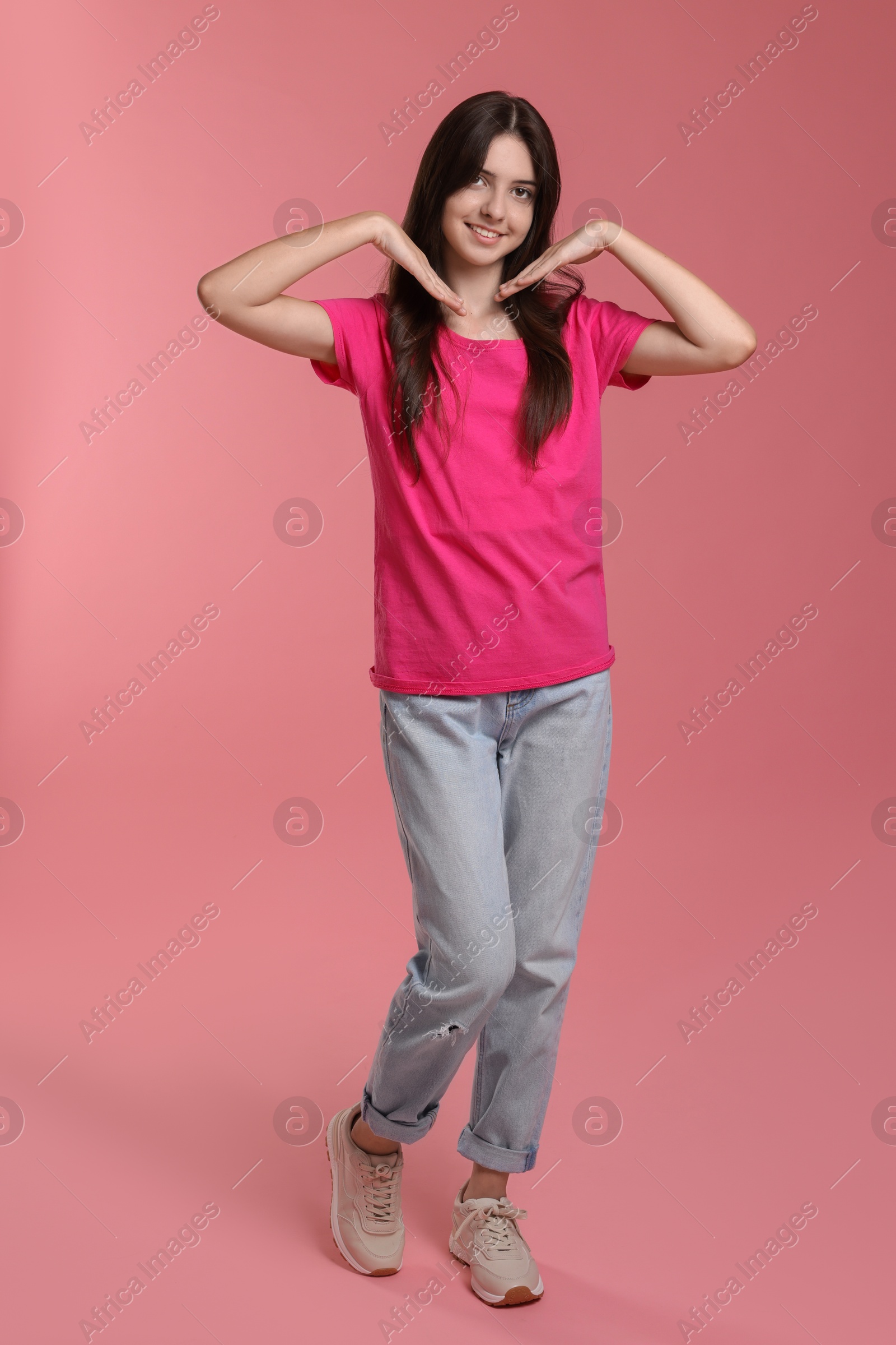 Photo of Full length portrait of cute teenage girl on pink background