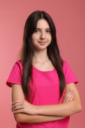 Photo of Portrait of cute teenage girl on pink background