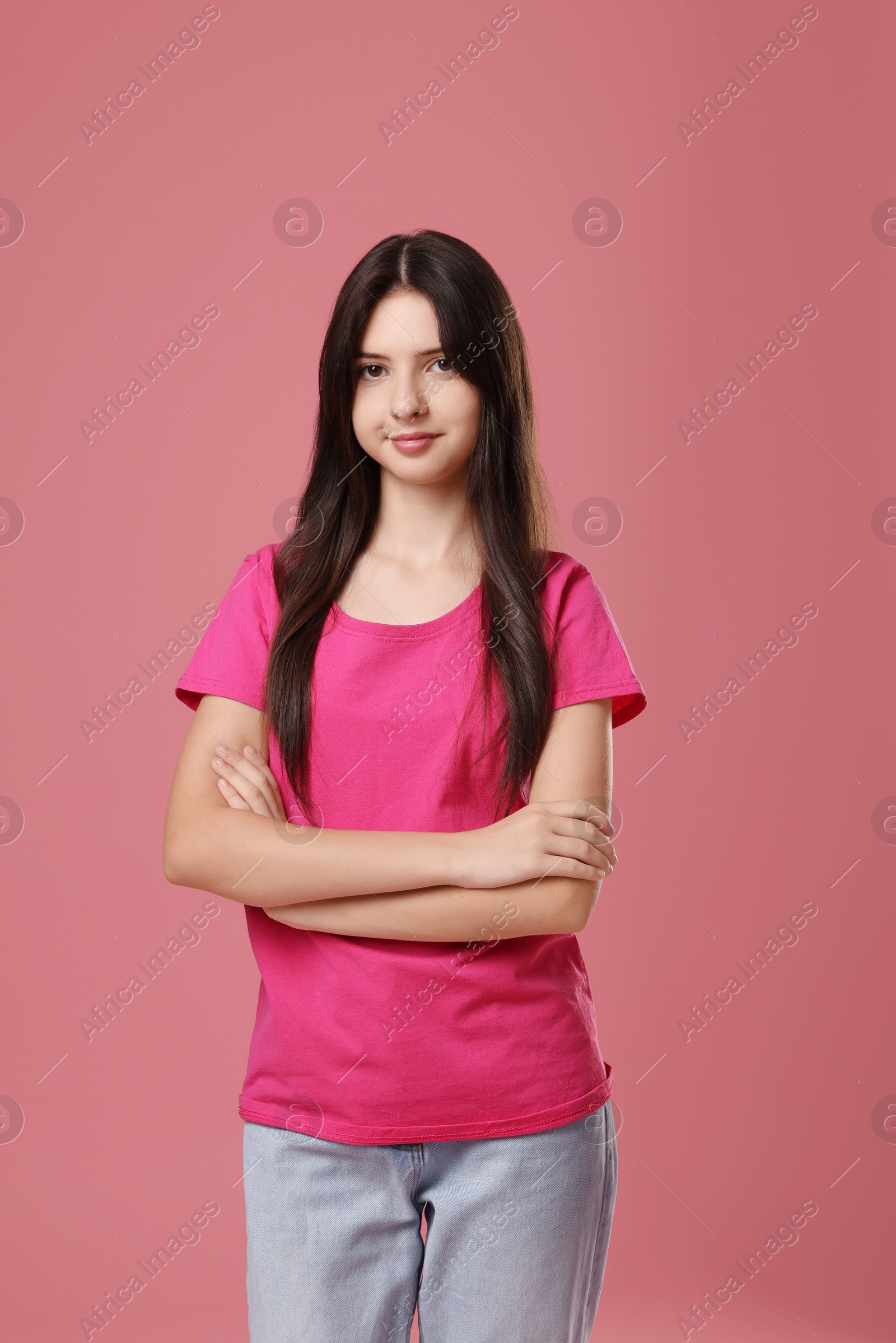 Photo of Portrait of cute teenage girl on pink background