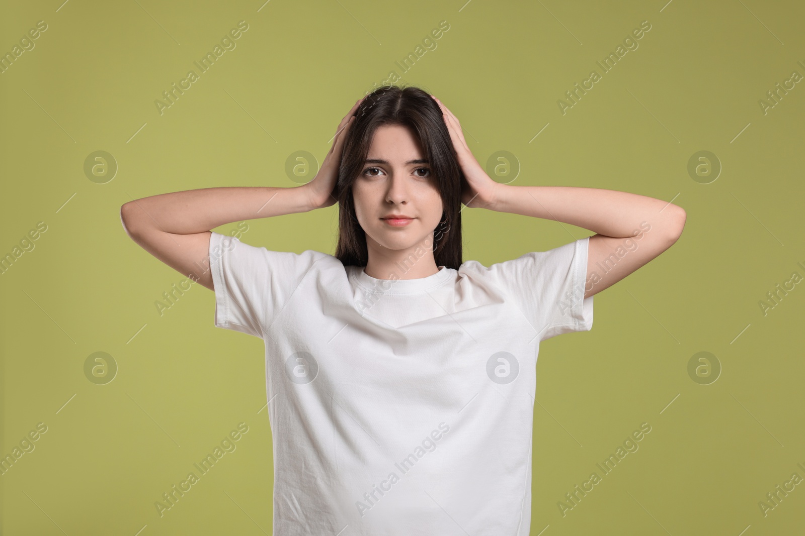 Photo of Portrait of cute teenage girl on olive background