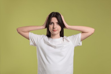 Portrait of cute teenage girl on olive background