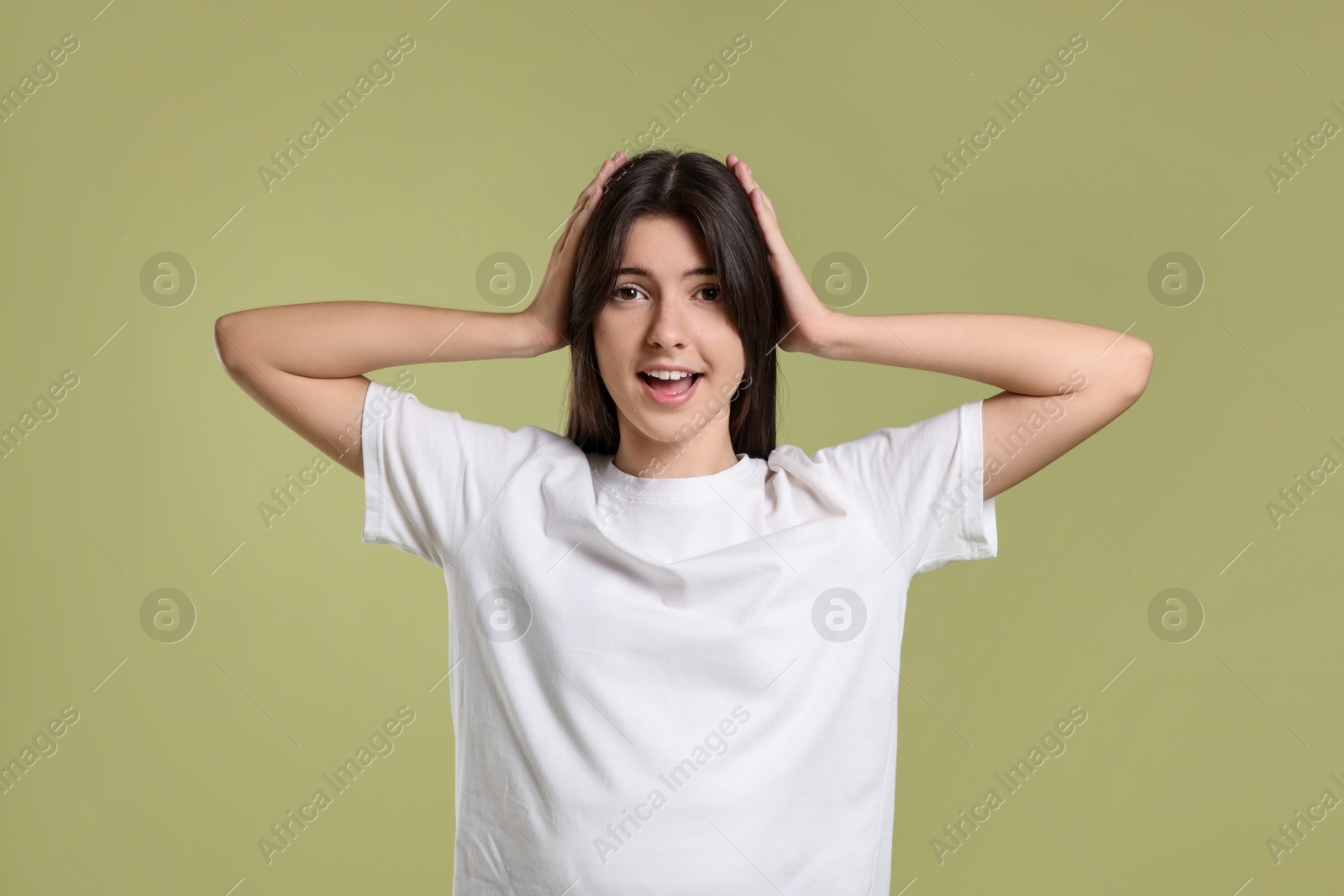 Photo of Portrait of cute teenage girl on olive background