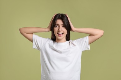 Portrait of cute teenage girl on olive background