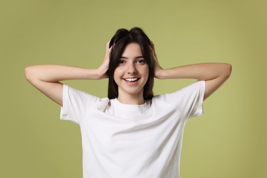 Photo of Portrait of cute teenage girl on olive background