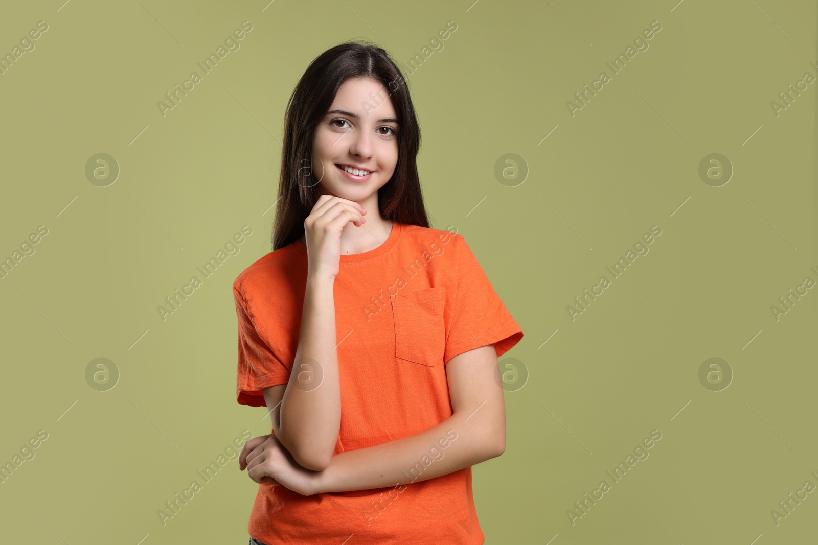 Photo of Portrait of cute teenage girl on olive background