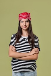 Portrait of cheerful teenage girl jumping on olive background