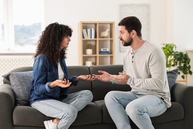 Emotional couple arguing at home. Relationship problems