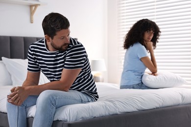 Couple having quarrel in bedroom, selective focus. Relationship problems