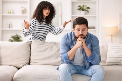 Photo of Couple having quarrel at home, selective focus. Relationship problems