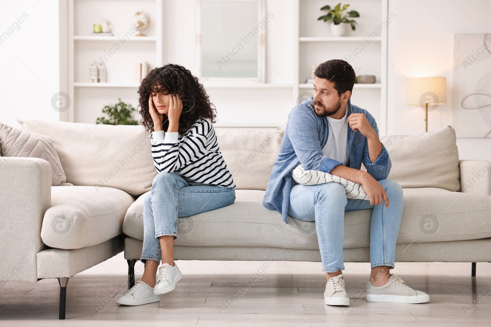 Photo of Couple having quarrel on sofa at home. Relationship problems