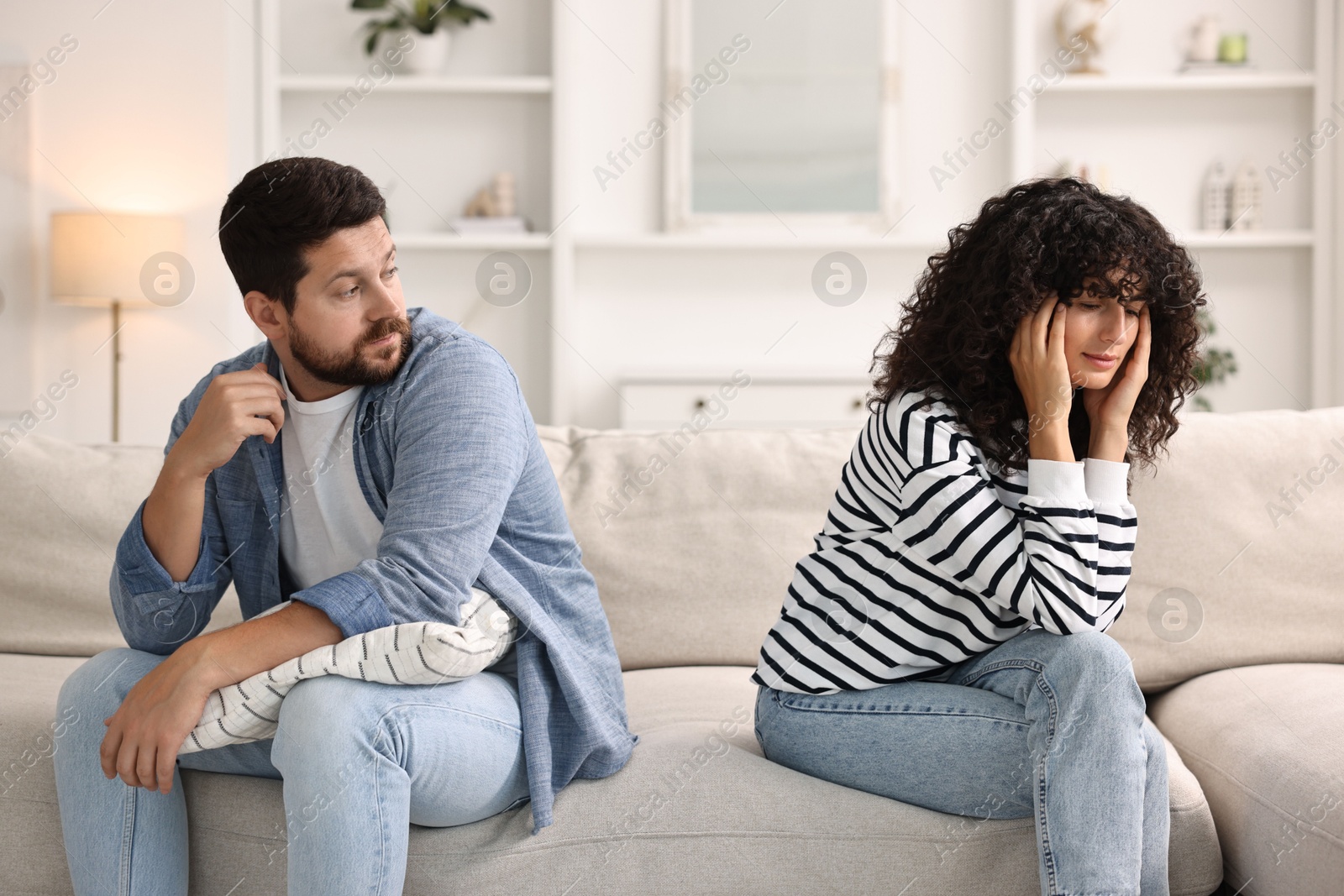 Photo of Couple having quarrel on sofa at home. Relationship problems